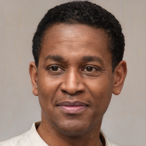 Joyful latino adult male with short  black hair and brown eyes