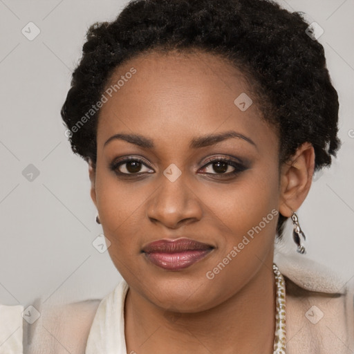 Joyful black young-adult female with short  brown hair and brown eyes