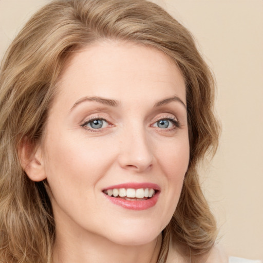 Joyful white young-adult female with long  brown hair and green eyes