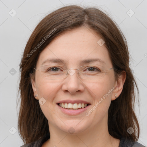 Joyful white adult female with long  brown hair and grey eyes