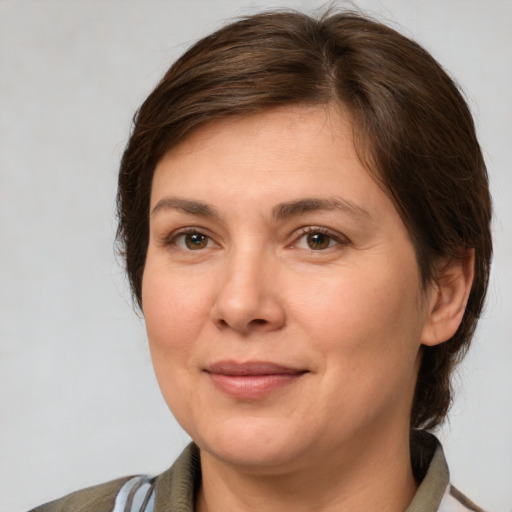 Joyful white adult female with medium  brown hair and grey eyes