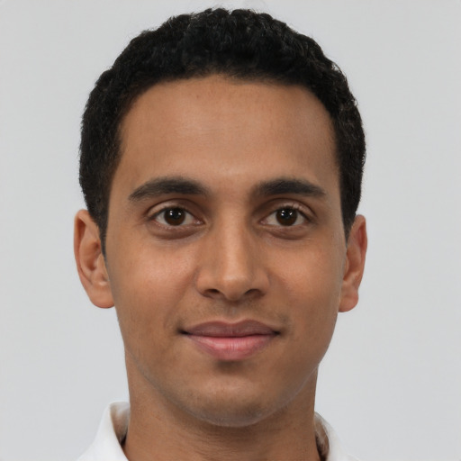 Joyful latino young-adult male with short  brown hair and brown eyes