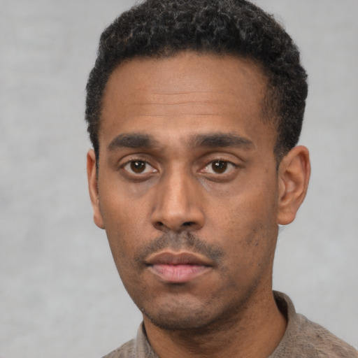 Neutral latino adult male with short  black hair and brown eyes
