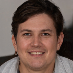 Joyful white young-adult male with short  brown hair and brown eyes