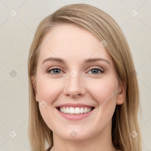 Joyful white young-adult female with long  brown hair and green eyes