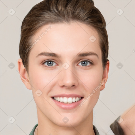 Joyful white young-adult female with short  brown hair and grey eyes