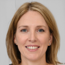 Joyful white adult female with medium  brown hair and grey eyes