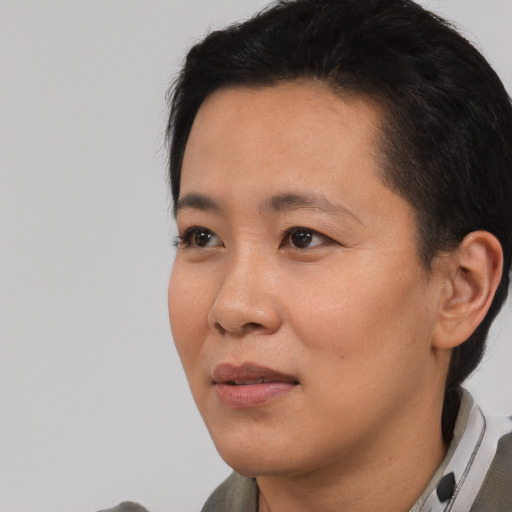 Joyful asian adult female with short  black hair and brown eyes