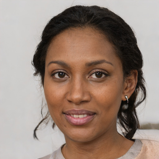 Joyful black young-adult female with medium  brown hair and brown eyes