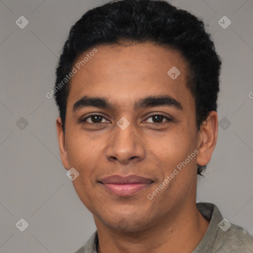 Joyful latino young-adult male with short  black hair and brown eyes