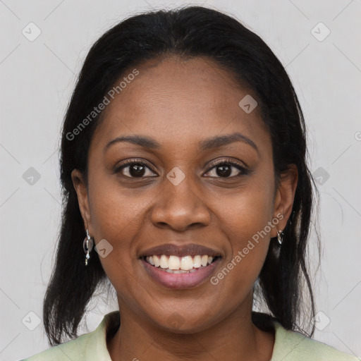 Joyful black young-adult female with long  black hair and brown eyes