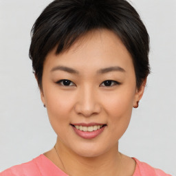 Joyful asian young-adult female with short  brown hair and brown eyes