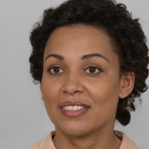 Joyful black young-adult female with medium  brown hair and brown eyes