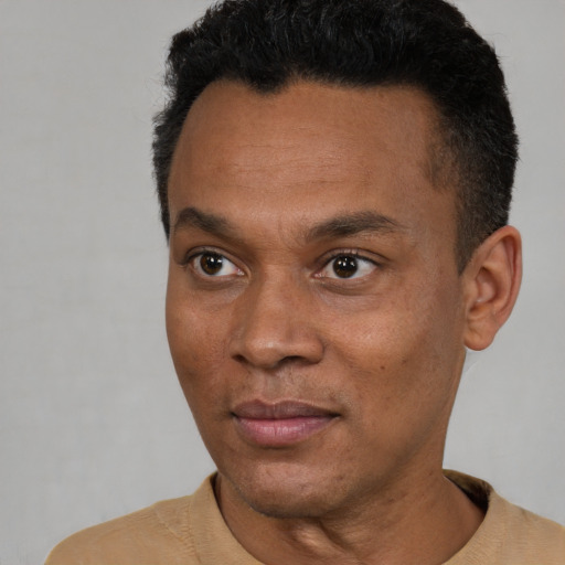 Joyful black young-adult male with short  black hair and brown eyes