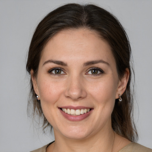 Joyful white young-adult female with medium  brown hair and brown eyes