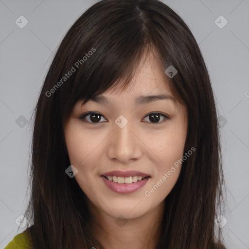 Joyful asian young-adult female with long  brown hair and brown eyes