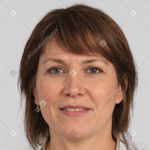 Joyful white adult female with medium  brown hair and grey eyes