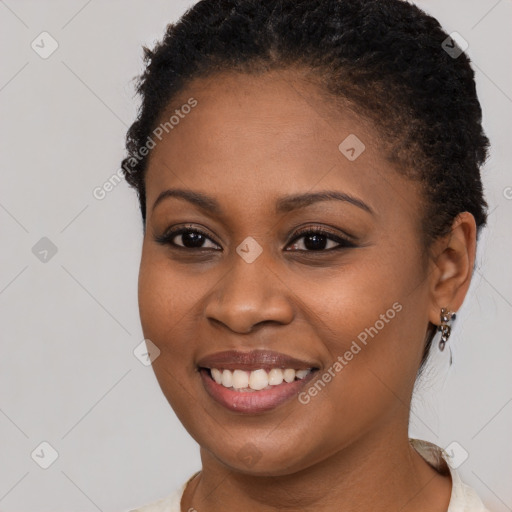 Joyful black young-adult female with short  brown hair and brown eyes