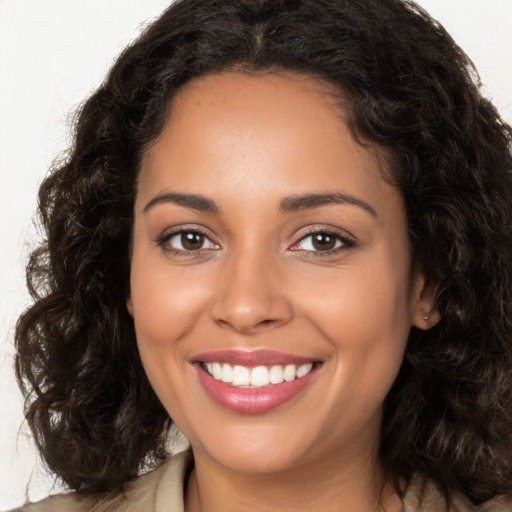 Joyful white young-adult female with long  brown hair and brown eyes