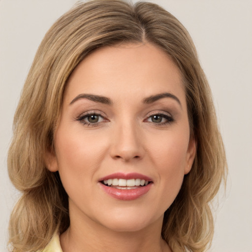 Joyful white young-adult female with medium  brown hair and brown eyes