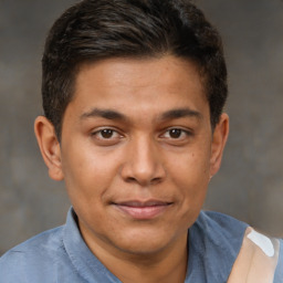 Joyful latino young-adult male with short  brown hair and brown eyes