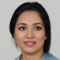 Joyful latino young-adult female with medium  brown hair and brown eyes