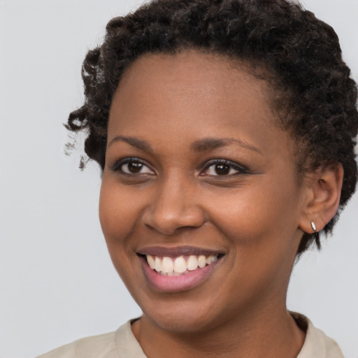 Joyful black young-adult female with short  brown hair and brown eyes