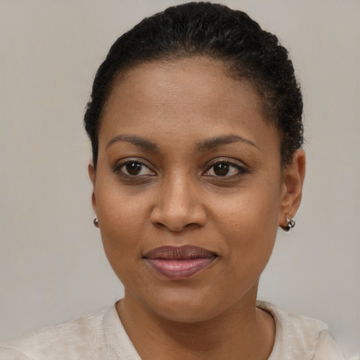 Joyful black young-adult female with short  brown hair and brown eyes