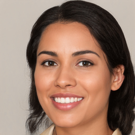 Joyful latino young-adult female with medium  black hair and brown eyes