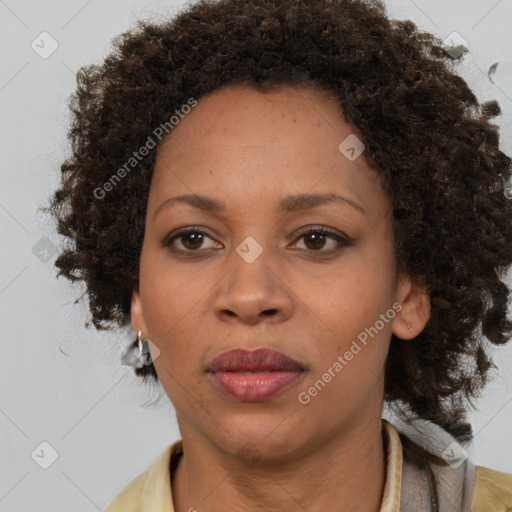 Joyful black adult female with medium  brown hair and brown eyes