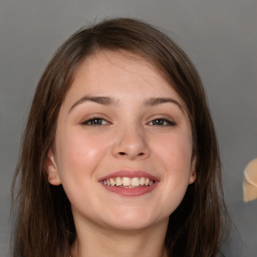 Joyful white young-adult female with long  brown hair and grey eyes