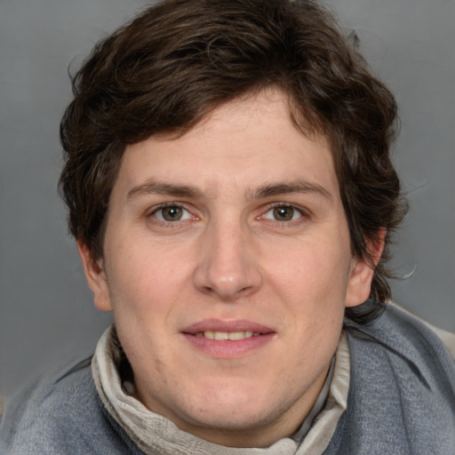 Joyful white young-adult male with short  brown hair and blue eyes