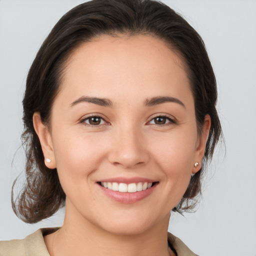 Joyful white young-adult female with medium  brown hair and brown eyes