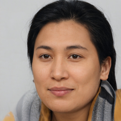 Joyful asian young-adult female with medium  brown hair and brown eyes