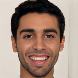 Joyful white young-adult male with short  black hair and brown eyes