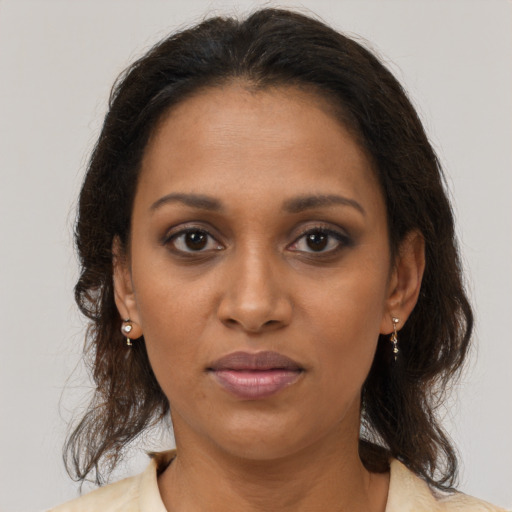 Joyful black young-adult female with medium  brown hair and brown eyes