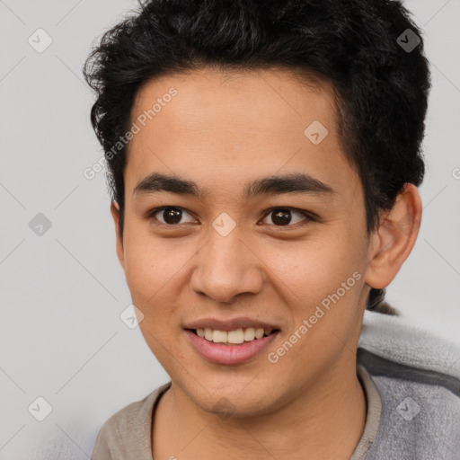 Joyful latino young-adult male with short  brown hair and brown eyes