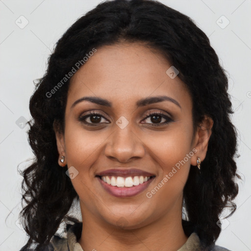 Joyful black young-adult female with long  black hair and brown eyes