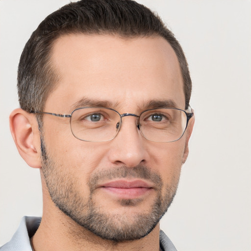 Joyful white adult male with short  brown hair and brown eyes