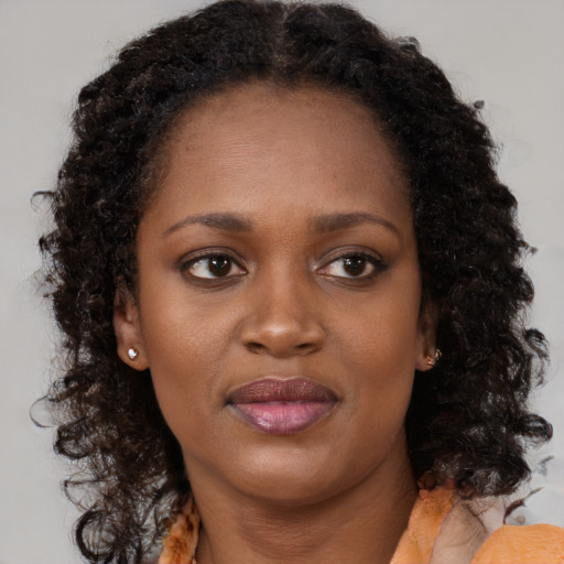 Neutral black young-adult female with medium  brown hair and brown eyes