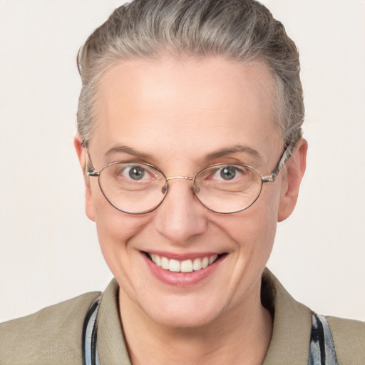 Joyful white adult female with short  brown hair and blue eyes