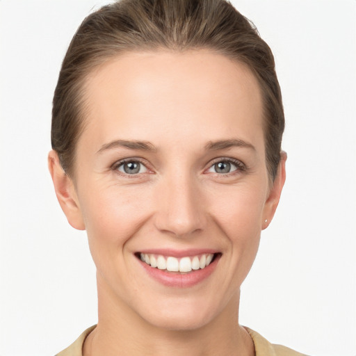 Joyful white young-adult female with medium  brown hair and grey eyes