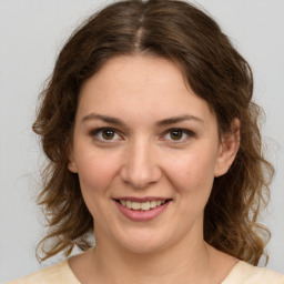 Joyful white young-adult female with medium  brown hair and brown eyes