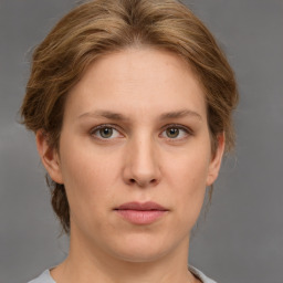 Joyful white young-adult female with medium  brown hair and green eyes