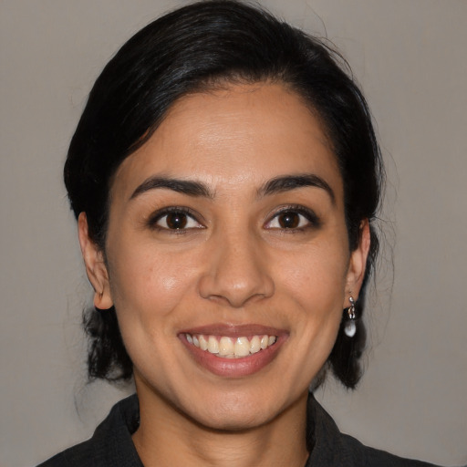 Joyful latino young-adult female with medium  black hair and brown eyes