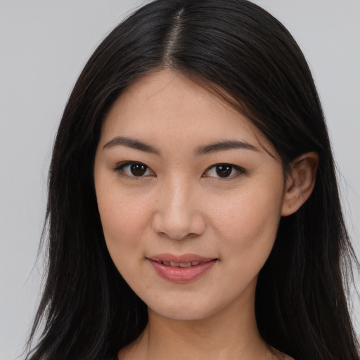 Joyful asian young-adult female with long  brown hair and brown eyes