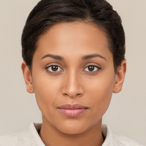 Joyful latino young-adult female with short  brown hair and brown eyes