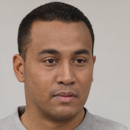 Neutral latino young-adult male with short  brown hair and brown eyes