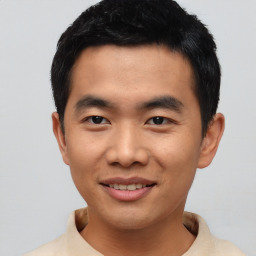 Joyful asian young-adult male with short  black hair and brown eyes