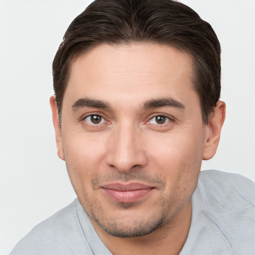 Joyful white young-adult male with short  brown hair and brown eyes